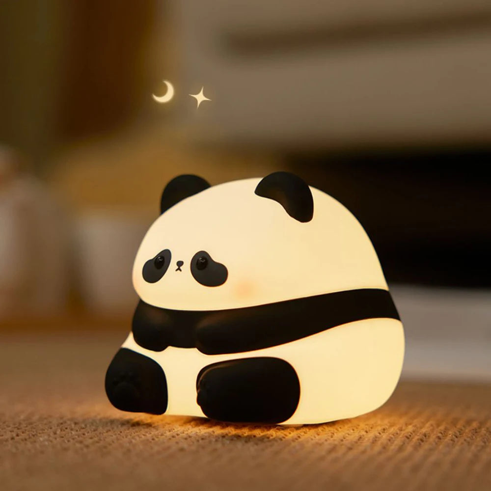 Cute panda-shaped night light on a wooden surface with a blurred background